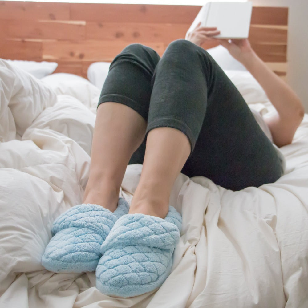 Women's Adjustable Spa Wrap Slippers in powder blue on figure laying back on bed reading book#color_powder-blue