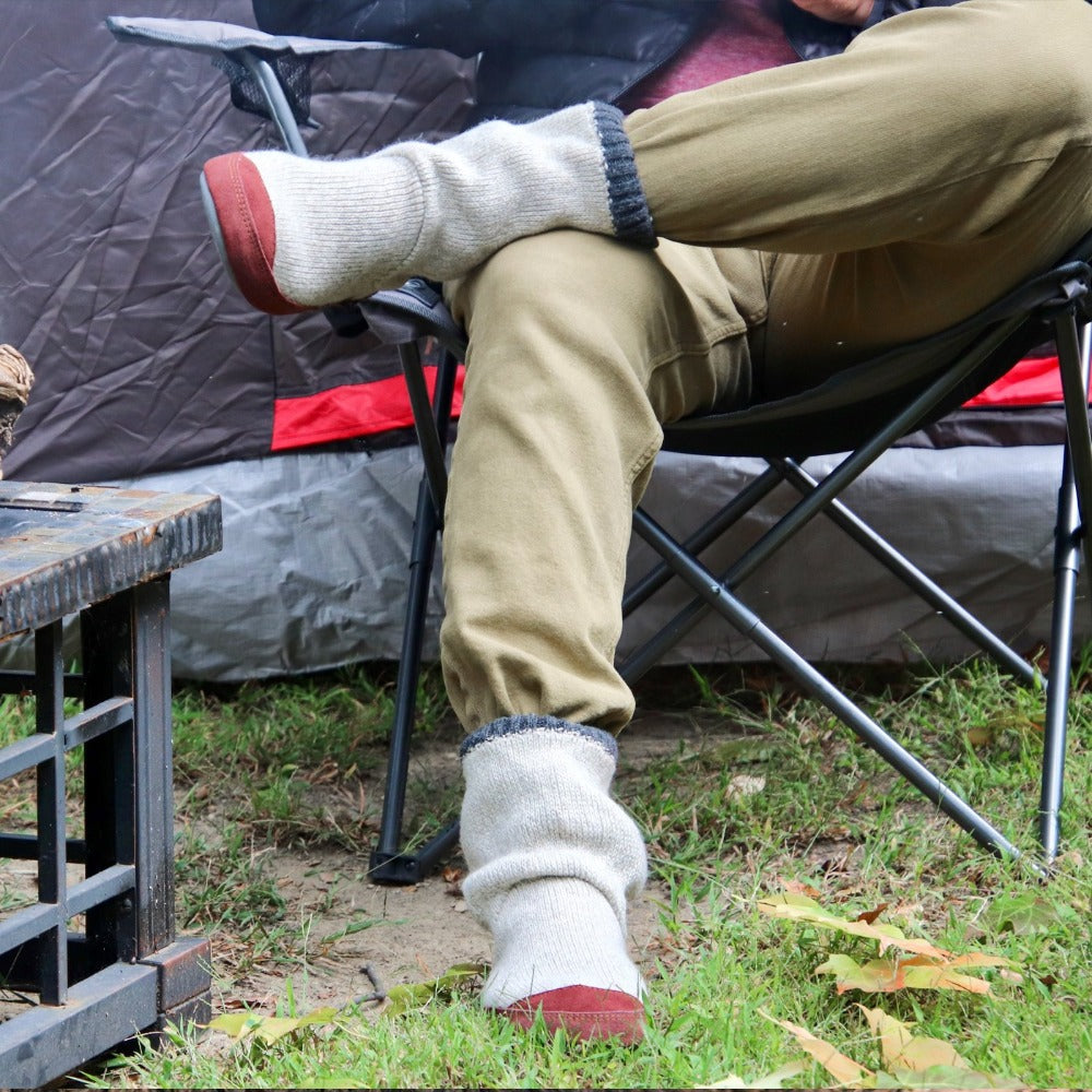 Men's Slouch Boots in Grey Ragg Wool On Model Sitting in Camping Chair by a Tent. Indoor / Outdoor Slipper Sock#color_grey-ragg-wool