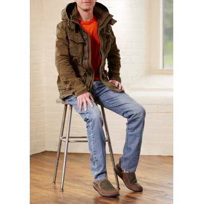Chocolate Acorn Slipper on model sitting on stool#color_olive-tweed